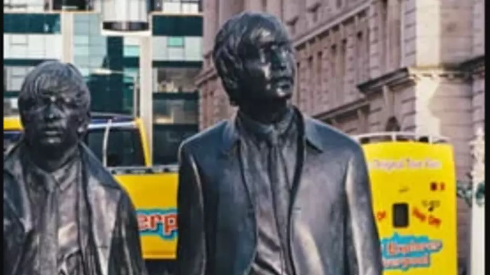John Lennon Statue in front of City Explorer Bus in Liverpool