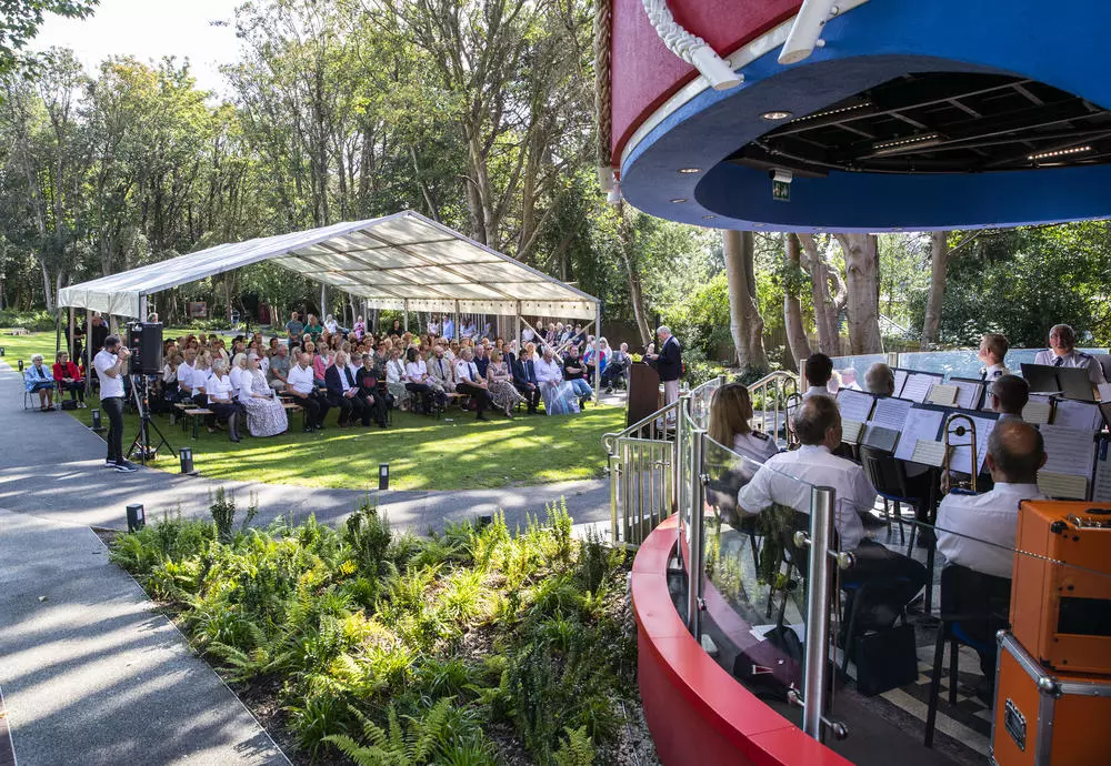 Guests watch Walton Salvation Army Band at the official dedication of the Strawberry Field Bandstand