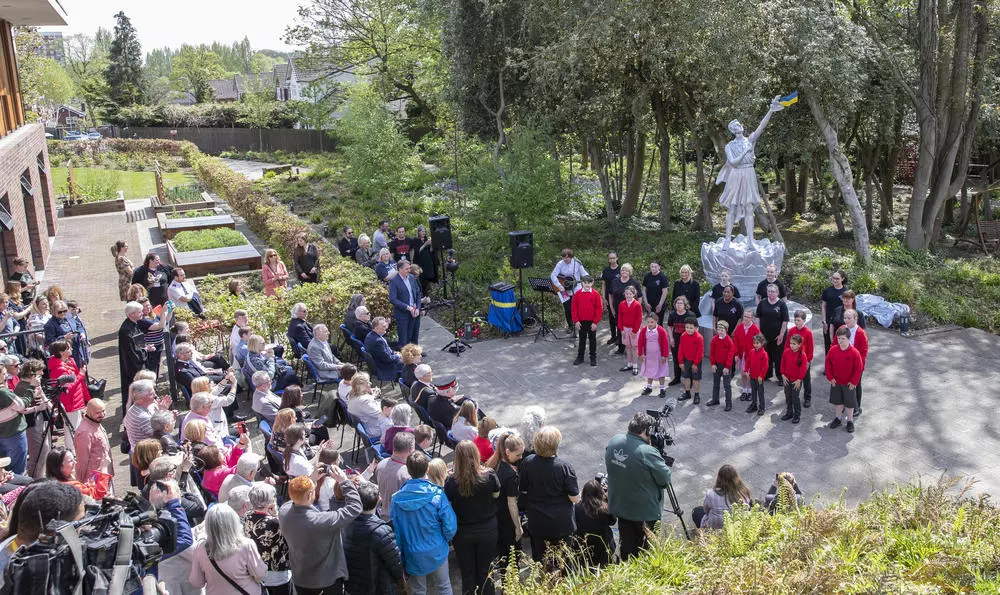 Guests and Liverpool Signing Choir at the unveiling of the Ukrainian Peace Monument at Strawberry Field Liverpool