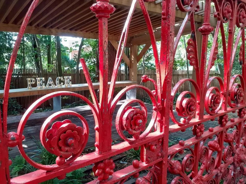 Strawberry Field Gates in front of a Peace sign