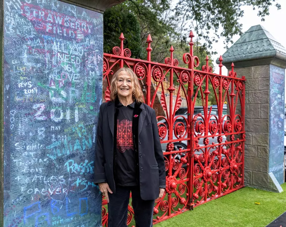 Julia Baird stood in front of Strawberry Field gates