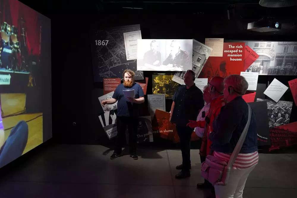 Visitors enjoy the immersive exhibition tour with upgraded accessibility features and a tour guide