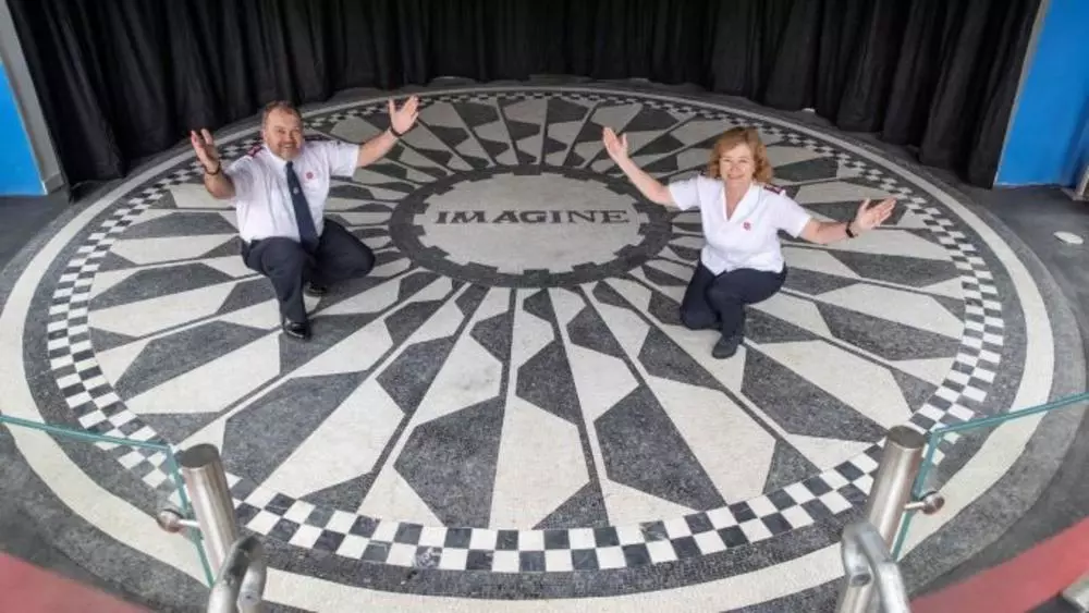 Major Allistair Versfeld and Major Kathy Versfeld with Image mosaic at Strawberry Field Liverpool