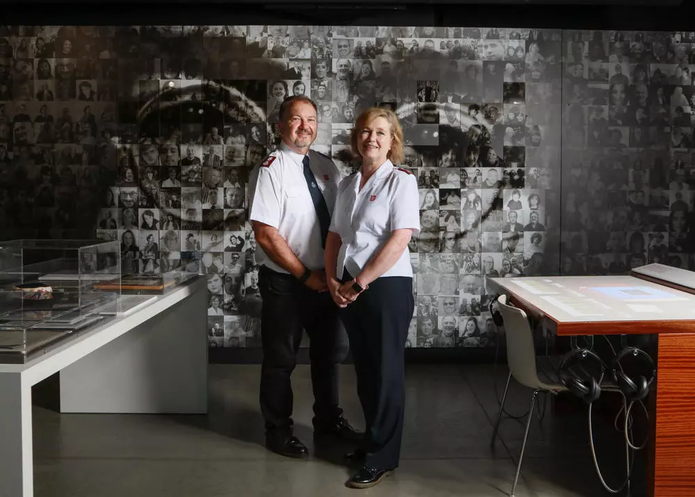 Major Allister Versfeld and Major Kathy Versfeld, in front of the John Lennon photomosaic