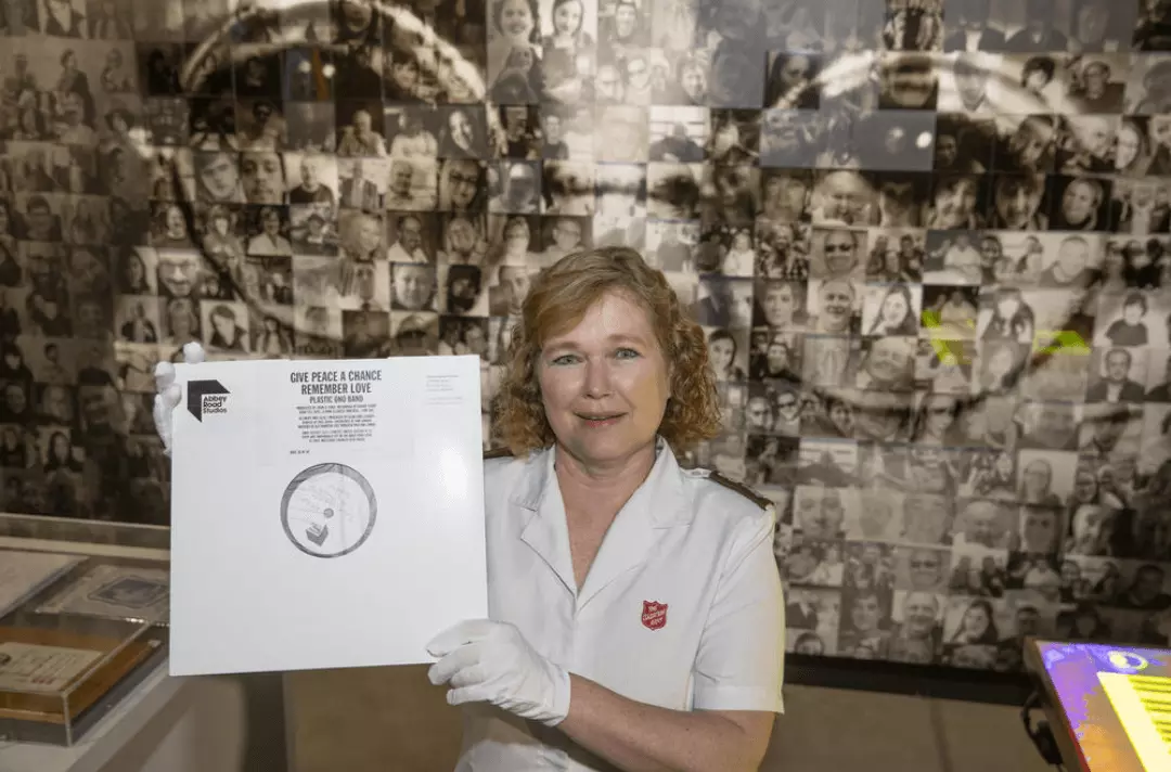 Major Kathy Versfeld holding the Give Peace a Chance vinyl