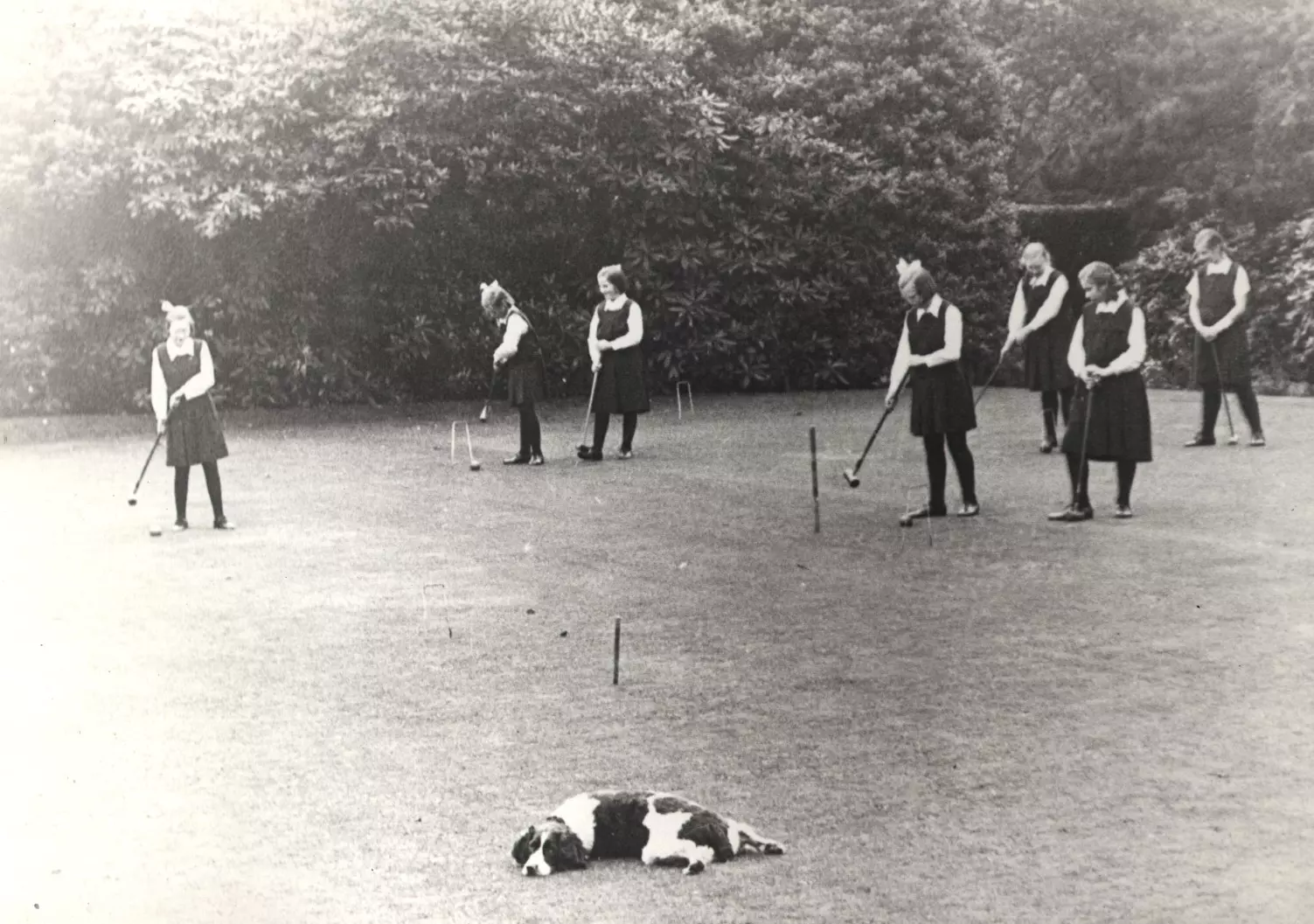 Girls playing croquet on the field at Strawberry Field
