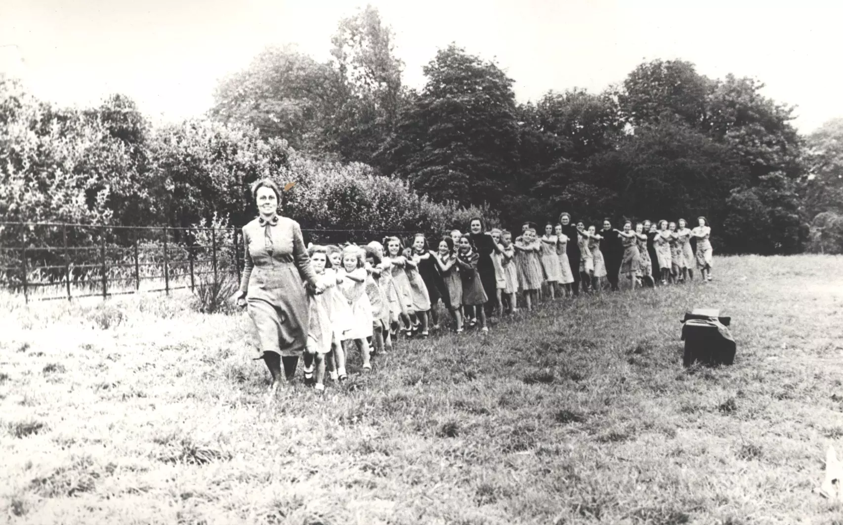 Children walking 'crocodile style' across the field