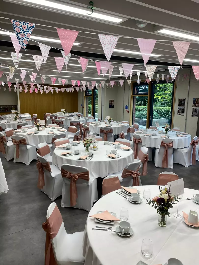 Bradbury Suite full of round tables and chairs dressed with table clothes