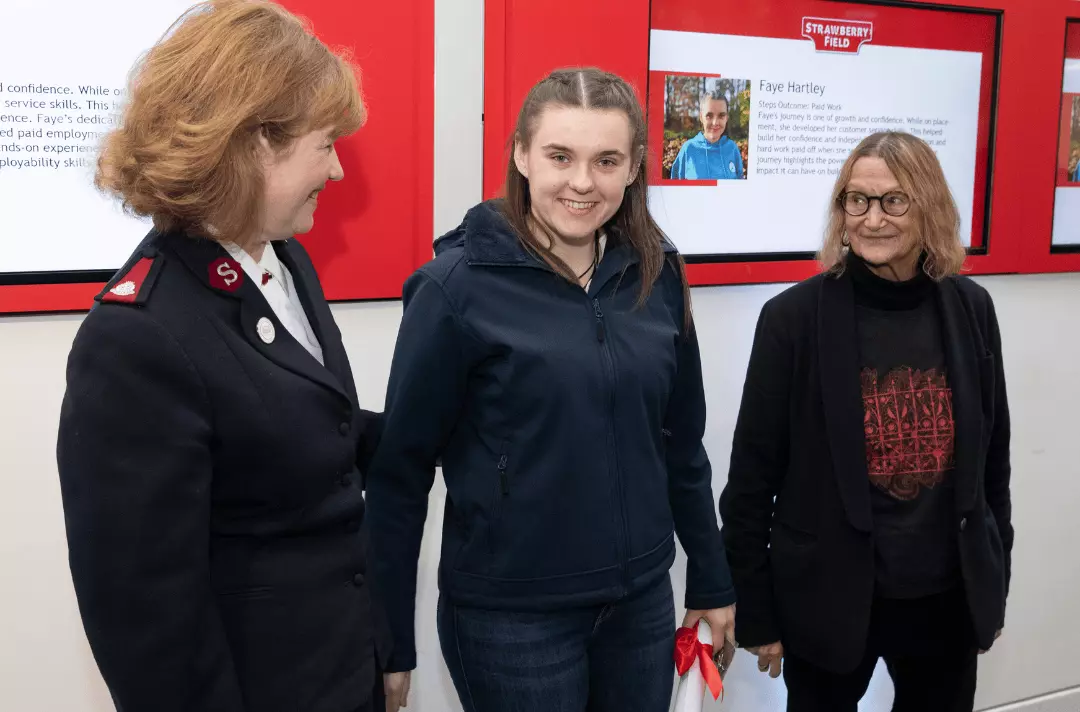 A Steps to Work graduate Faye stands between Major Kathy Versfeld and Julia Baird