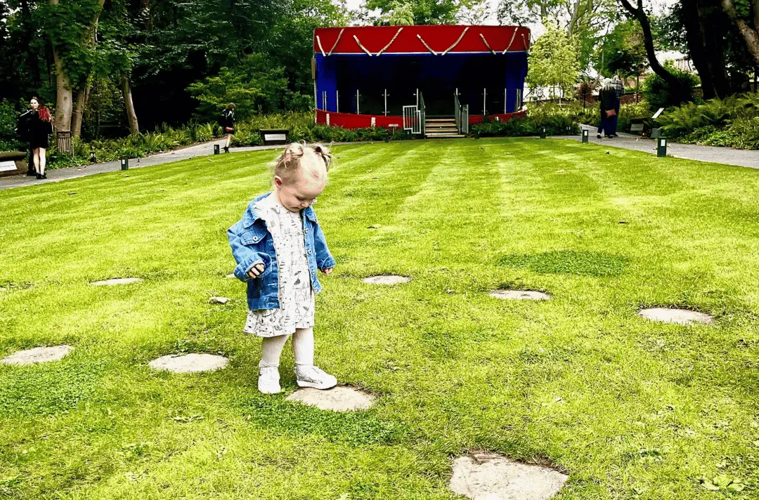 A little girl walks the Labyrinth at Strawberry Field