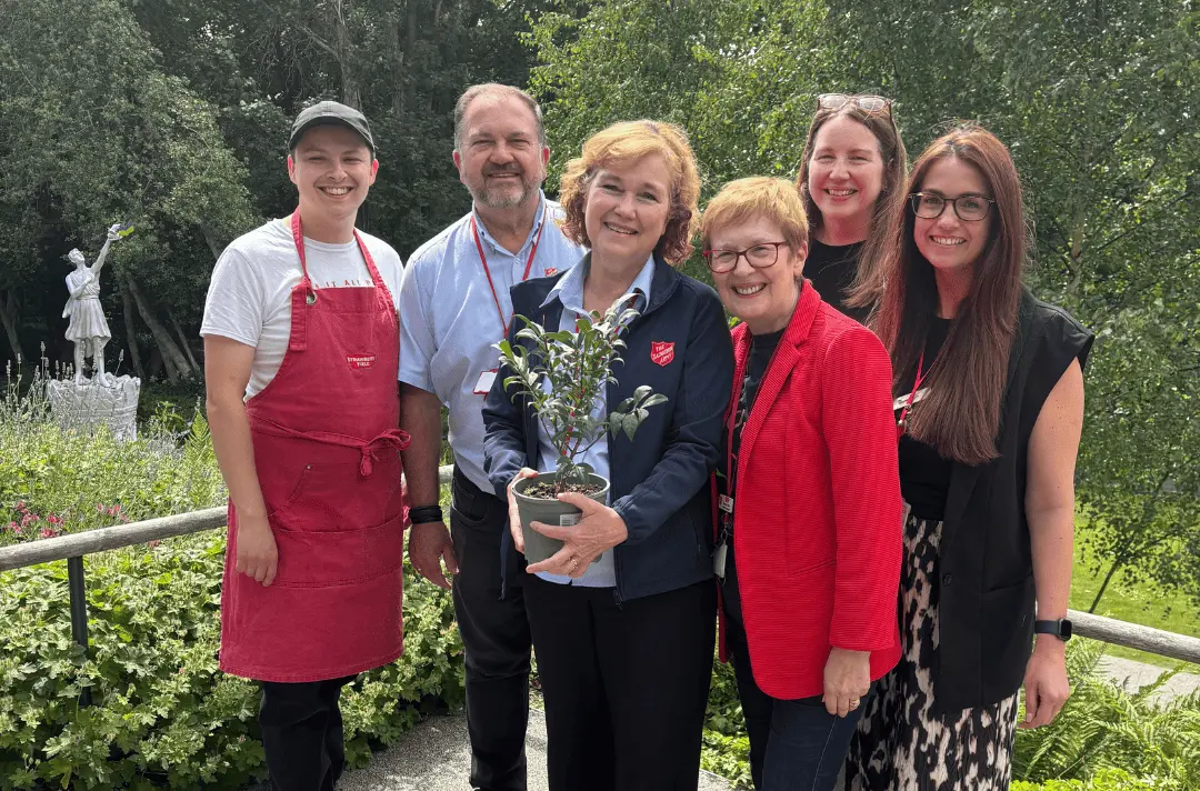 Members of the Green Team gift a 'Burning Bush' to Major Kathy and Major Allister Versfeld