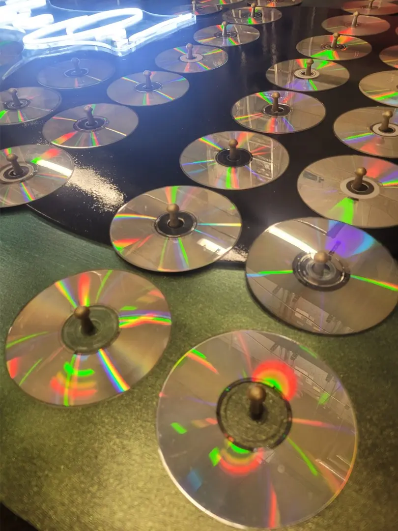 Close up on Steffs art work, with CDs on little pegs.