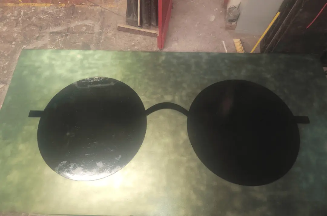 Steff's art work, a green board with John Lennon's sunglasses painted on it.