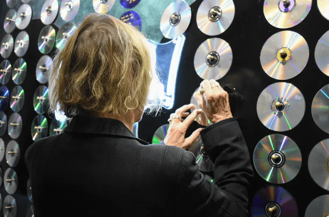 Julia Baird signs a CD on the Shine On wall