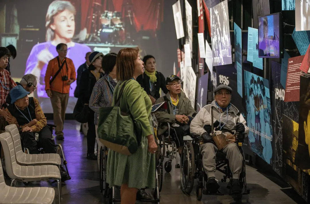 Visitors in the Strawberry Field exhibition, some of which are using wheelchairs